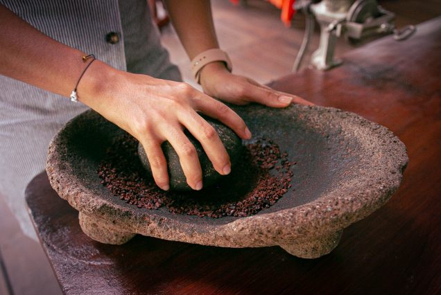 A person is putting the Chocolate Experience Tour into a bowl on a table.