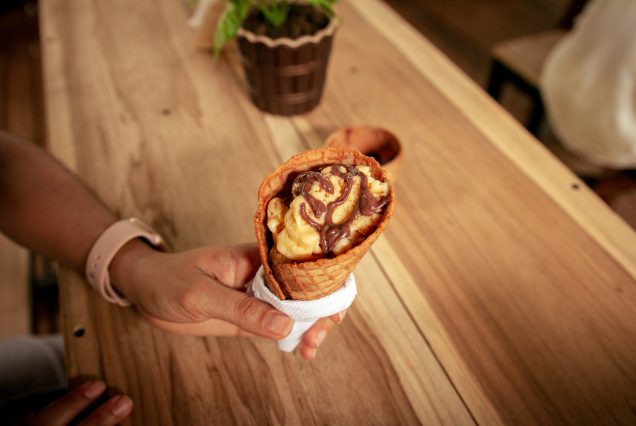 A person enjoying a Chocolate Experience Tour on a wooden table.