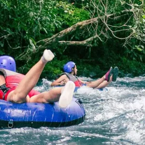 Two people enjoying a Tubing Tour In The Rio Celeste.