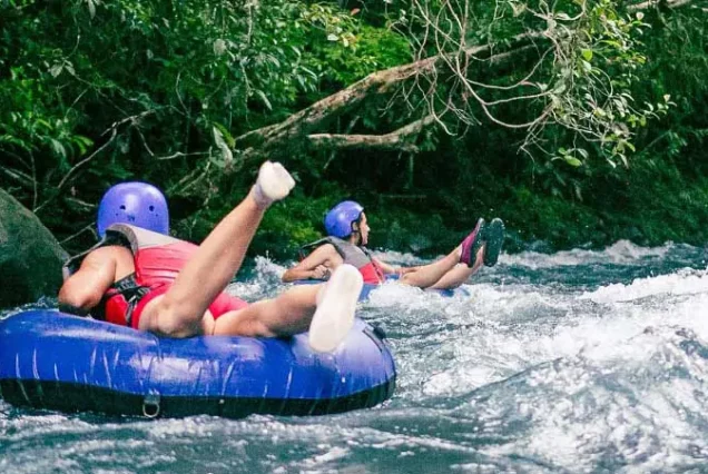 Two people enjoying a Tubing Tour In The Rio Celeste.