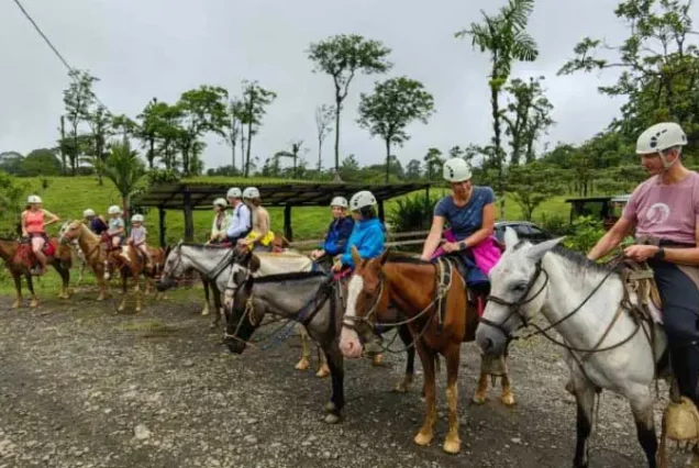 A group of people enjoying Rio Celeste Horseback Riding on a dirt road in Rio Celeste.