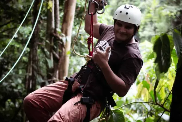 A man Rio Celeste Zip-lining through the lush jungles of Rio Celeste.