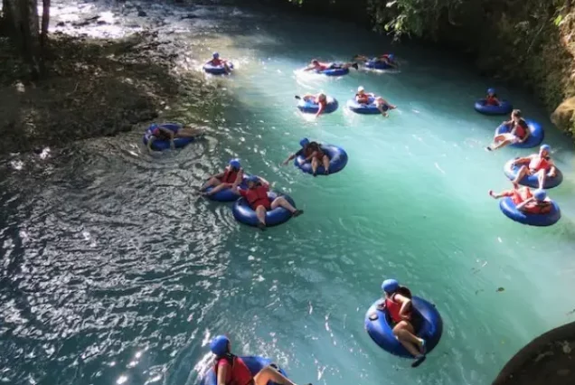 A group of people riding tubes down a river.