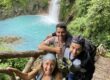 A group of friends having behind the Rio Celeste Waterfall