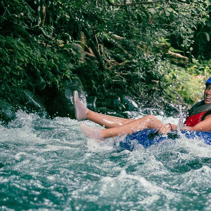 Girl tubing down in Rio Celeste