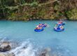 A group of people tubing in Rio Celeste