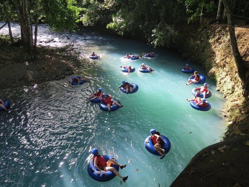 A group of people tubing down on rio celeste